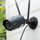 et svart kamera på en hvit vegg